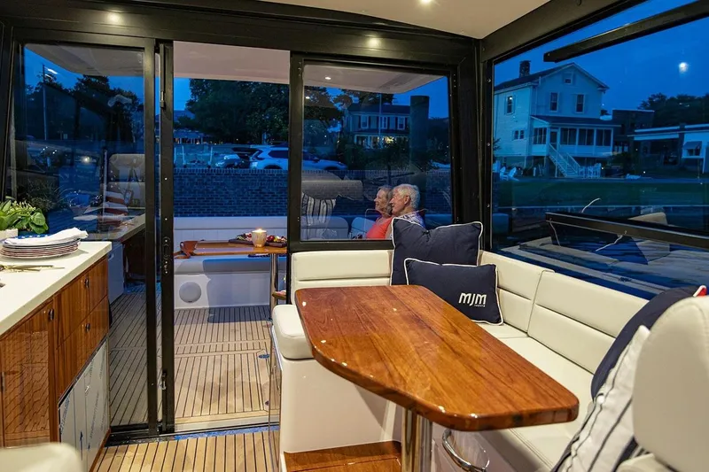 Slide: The Image of Luxurious interior of 2026 MJM 47 R yacht with elegant seating and wooden table. - 6