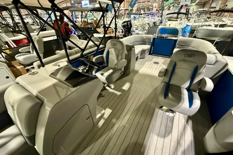 Slide: The Image of 2025 Bentley Pontoons Legacy 243 Navigator, blue pontoon boat displayed indoors. - 7
