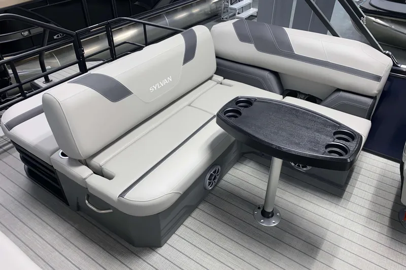 Slide: The Image of Luxurious seating area on 2025 Sylvan L3 CLZ DH pontoon boat with table and cup holders. - 10