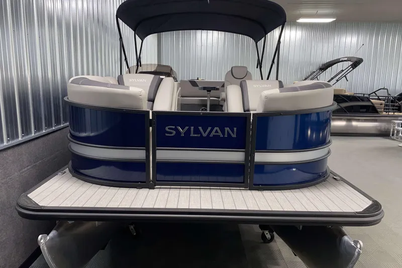 Slide: The Image of 2025 Sylvan L3 CLZ DH pontoon boat with blue exterior in showroom. - 14