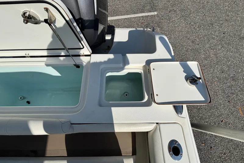 Slide: The Image of 2012 Sea Hunt Gamefish 29 boat deck with open storage compartments. - 11