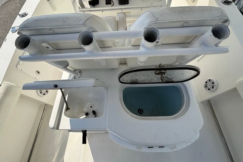 Slide: The Image of 2012 Sea Hunt Gamefish 29 boat interior with rod holders and livewell. - 13