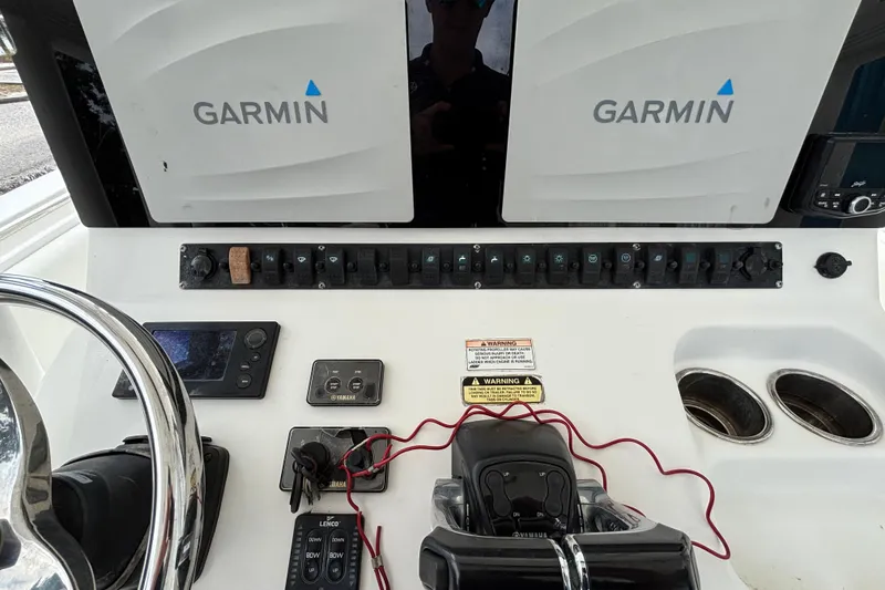 Slide: The Image of 2012 Sea Hunt Gamefish 29 dashboard with Garmin displays and Yamaha controls. - 22
