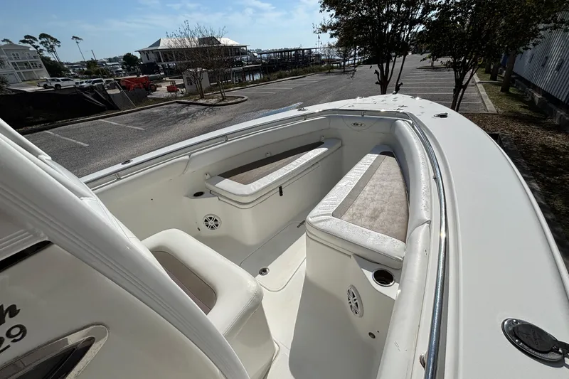 Slide: The Image of 2012 Sea Hunt Gamefish 29 boat interior with cushioned seating and cup holders. - 23