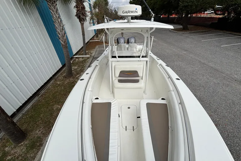 Slide: The Image of 2012 Sea Hunt Gamefish 29 boat with Garmin equipment, docked near palm trees. - 27