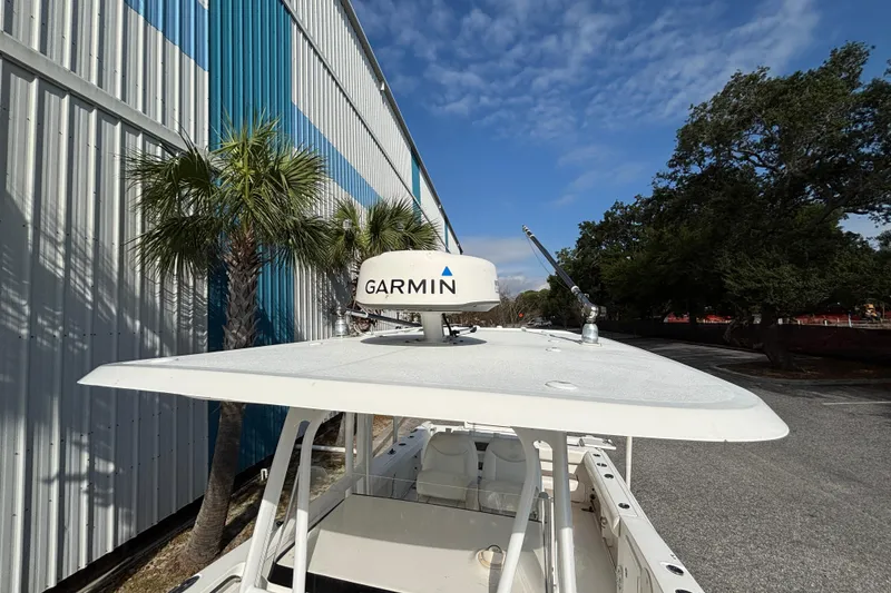 Slide: The Image of 2012 Sea Hunt Gamefish 29 with Garmin radar, parked near a blue and white building. - 28