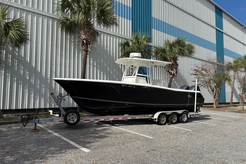 Slide: The Image of 2012 Sea Hunt Gamefish 29 boat on trailer, parked near palm trees. - 3