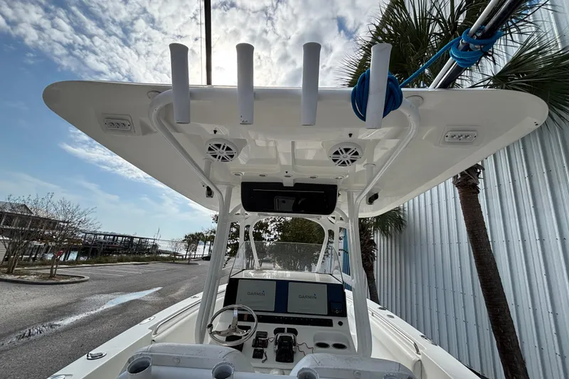 Slide: The Image of 2012 Sea Hunt Gamefish 29 boat console with T-top and Garmin navigation system. - 30