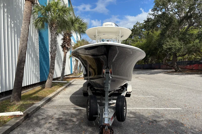 Slide: The Image of 2012 Sea Hunt Gamefish 29 boat on trailer, parked near palm trees. - 5