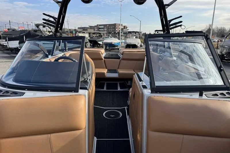 Slide: The Image of 2026 Moomba Mondo boat interior with tan seating and open windshield design. - 15