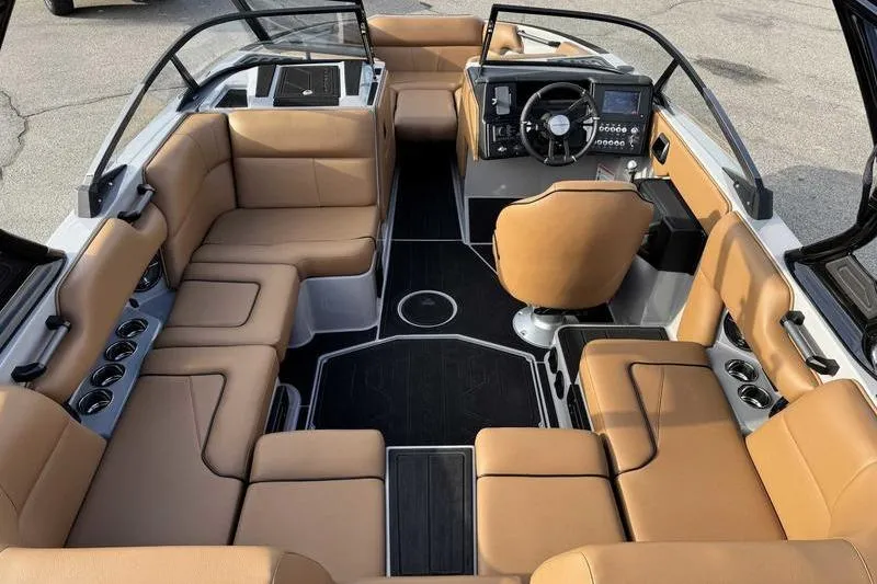 Slide: The Image of 2026 Moomba Mondo boat interior with tan seating and modern dashboard design. - 3