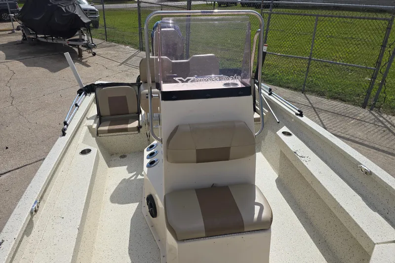 Slide: The Image of 2021 Xpress H22B Bay boat with beige seating and console, parked outdoors. - 10