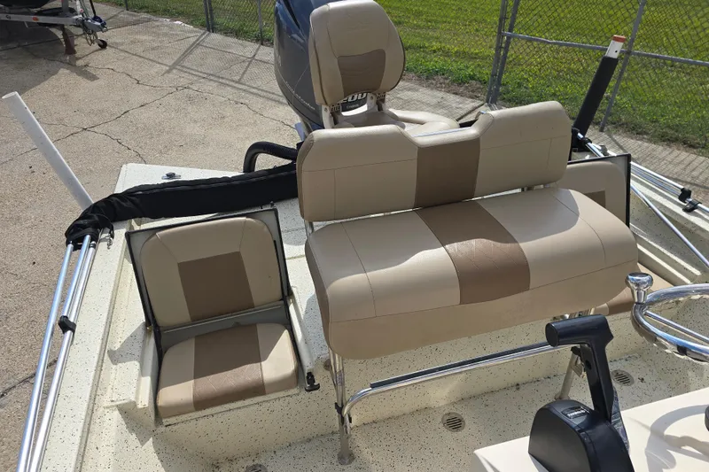 Slide: The Image of 2021 Xpress H22B Bay boat interior with beige seating and steering console. - 11