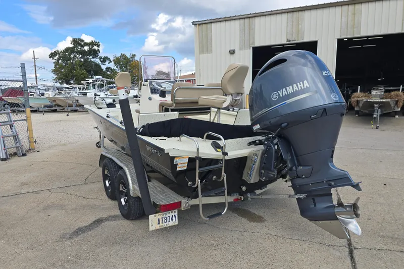 Slide: The Image of 2021 Xpress H22B Bay boat with Yamaha engine parked outdoors. - 4