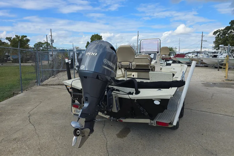 Slide: The Image of 2021 Xpress H22B Bay boat with Yamaha 200 engine, parked outdoors. - 5