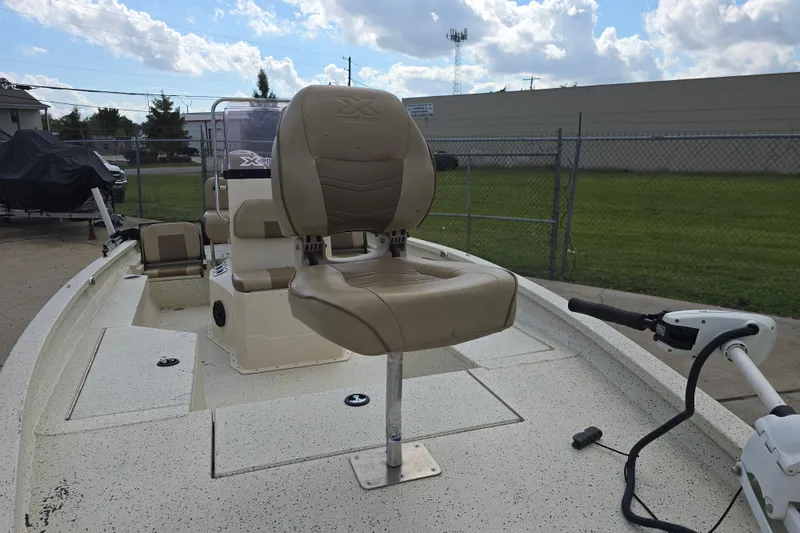 Slide: The Image of 2021 Xpress H22B Bay boat with beige seating and trolling motor. - 7