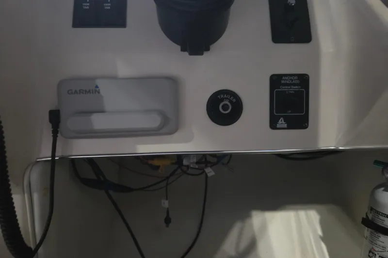 Slide: The Image of 1996 Sea Ray 290 Sundancer dashboard with Garmin device and anchor windlass control. - 12