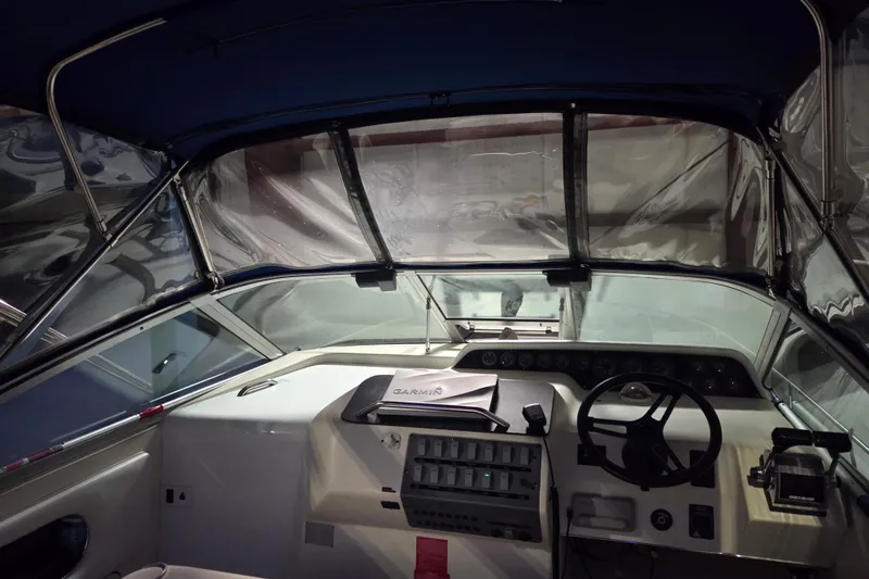 Slide: The Image of Interior view of 1996 Sea Ray 290 Sundancer boat cockpit with steering wheel and controls. - 14