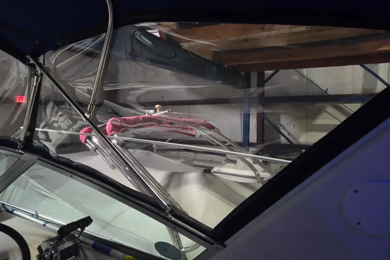 Slide: The Image of 1996 Sea Ray 290 Sundancer boat interior with windshield and controls. - 15