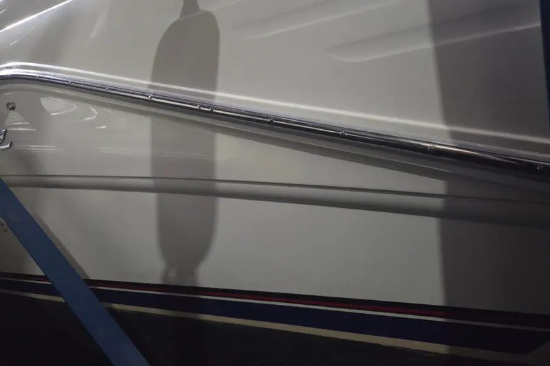 Slide: The Image of 1996 Sea Ray 290 Sundancer boat hull with railing and shadow detail. - 2