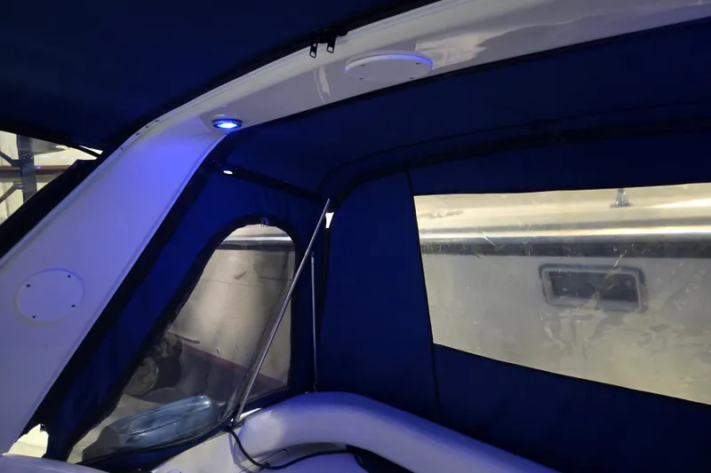Slide: The Image of Interior view of 1996 Sea Ray 290 Sundancer with blue lighting and canopy. - 21
