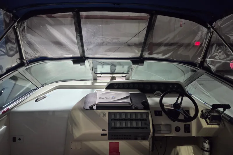 Slide: The Image of 1996 Sea Ray 290 Sundancer cockpit with steering wheel, control panel, and Garmin equipment. - 3