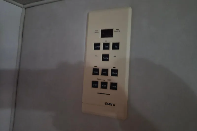 Slide: The Image of Control panel of a 1996 Sea Ray 290 Sundancer boat, featuring temperature and fan settings. - 30