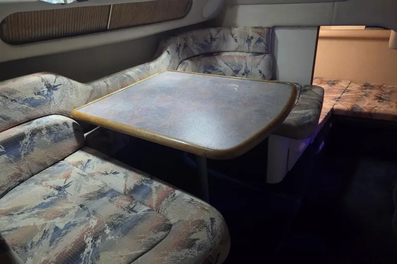 Slide: The Image of 1996 Sea Ray 290 Sundancer cabin with patterned seating and table. - 35