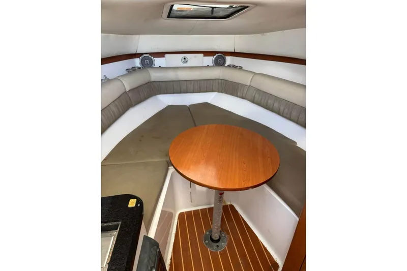 Slide: The Image of 2008 Century 2600 Walk-Around boat docked by waterfront homes. - 2