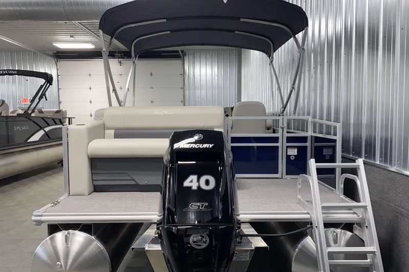Slide: The Image of 2025 SunChaser Vista 20 CRB pontoon boat with Mercury 40 HP engine in showroom. - 19