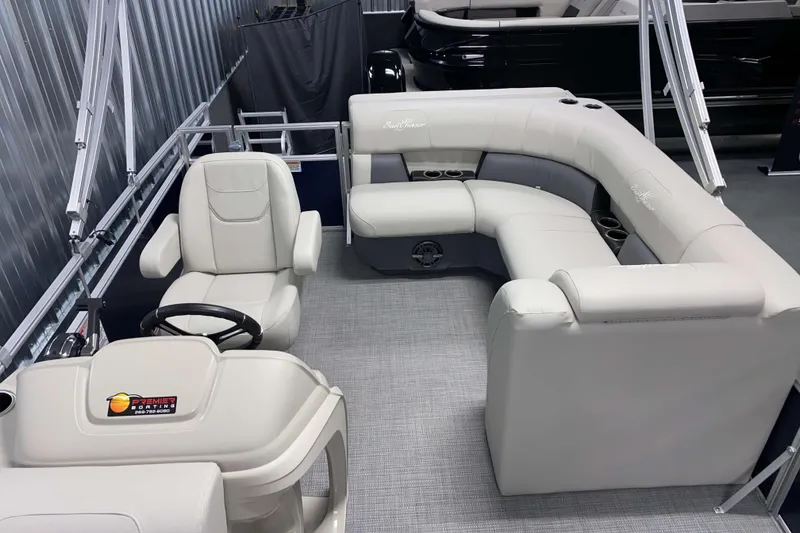 Slide: The Image of 2025 SunChaser Vista 20 CRB pontoon boat interior with plush seating and steering console. - 5