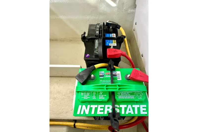 Slide: The Image of Interstate battery setup in 2006 Cobalt 272 boat, featuring red and black cables. - 23