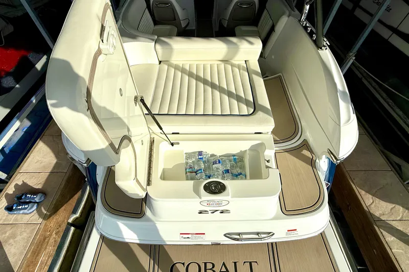 Slide: The Image of 2006 Cobalt 272 boat interior with open storage compartment and cushioned seating. - 26