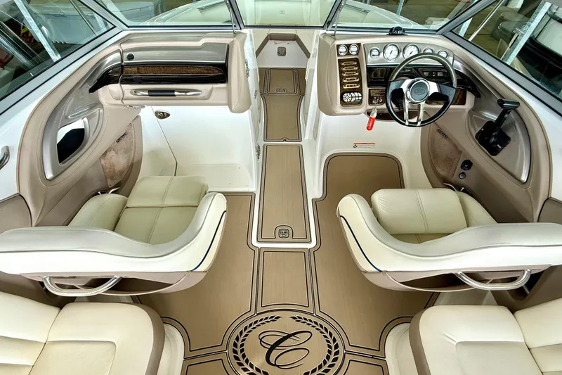 Slide: The Image of Interior of a 2006 Cobalt 272 boat featuring luxurious seating and a sleek dashboard. - 31