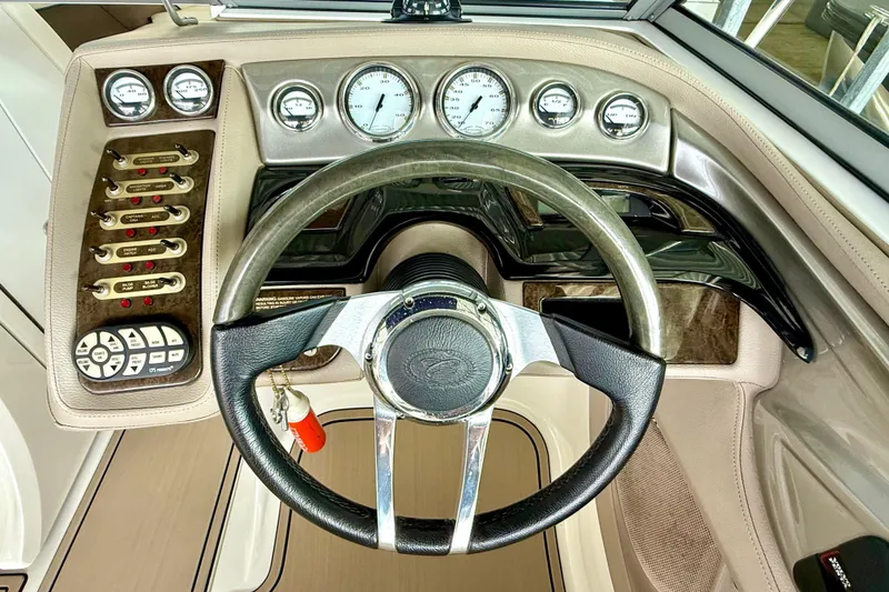 Slide: The Image of 2006 Cobalt 272 boat dashboard with steering wheel and control panel. - 33