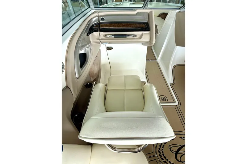 Slide: The Image of 2006 Cobalt 272 boat interior with beige leather seating and wood accents. - 34