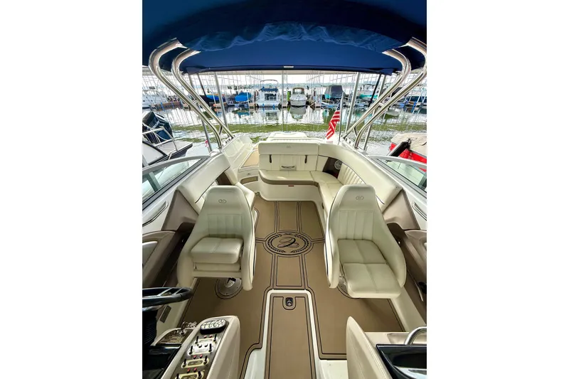 Slide: The Image of Interior of a 2006 Cobalt 272 boat with luxurious seating and blue canopy. - 39