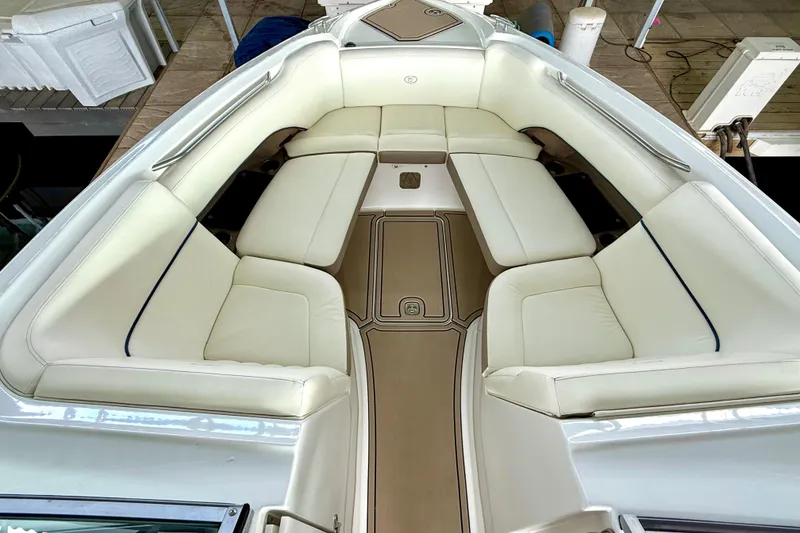 Slide: The Image of 2006 Cobalt 272 boat interior with white cushioned seating and brown flooring. - 40