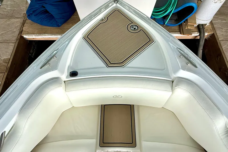 Slide: The Image of 2006 Cobalt 272 boat interior with white seating and wooden deck accents. - 43