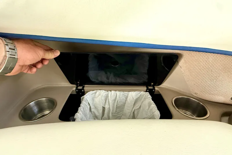 Slide: The Image of Hand opening storage compartment in 2006 Cobalt 272 boat interior. - 45