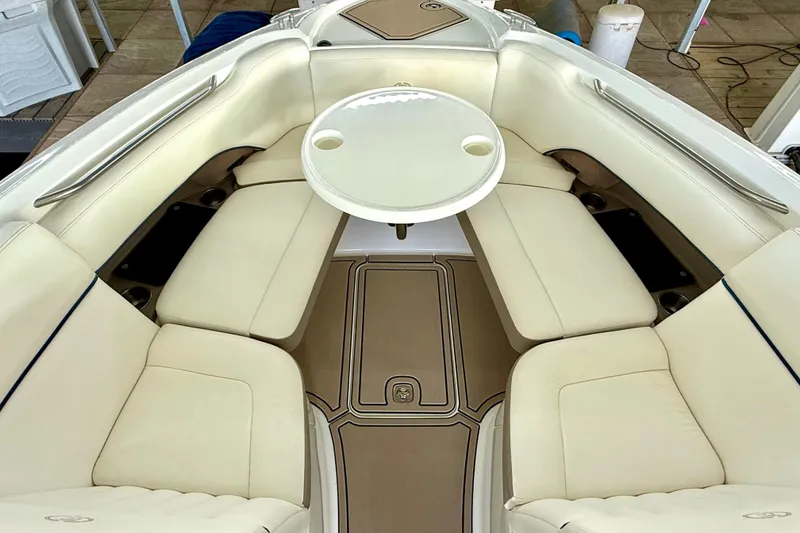 Slide: The Image of Luxurious interior of a 2006 Cobalt 272 boat with cream leather seating and a round table. - 47