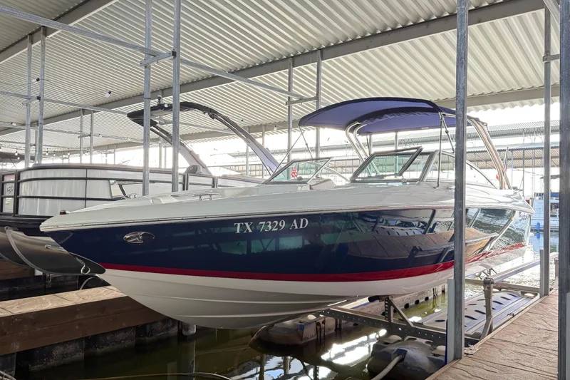 Slide: The Image of 2006 Cobalt 272 boat docked in a covered marina, side view. - 49