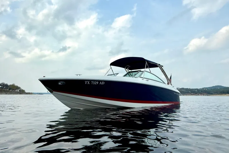 Slide: The Image of 2006 Cobalt 272 boat on calm water under a cloudy sky. - 5