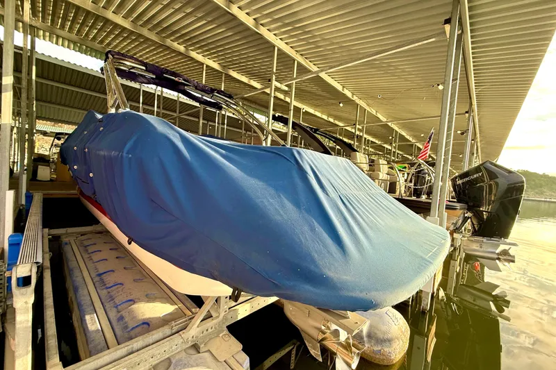 Slide: The Image of Covered 2006 Cobalt 272 boat docked under a metal canopy. - 57