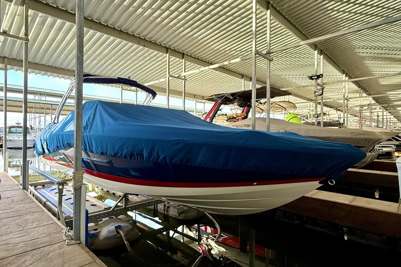 Slide: The Image of 2006 Cobalt 272 boat with blue cover in a marina dock. - 59