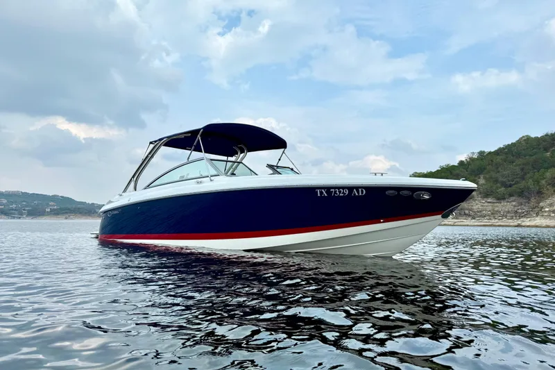 Slide: The Image of 2006 Cobalt 272 boat on calm water under a cloudy sky. - 6