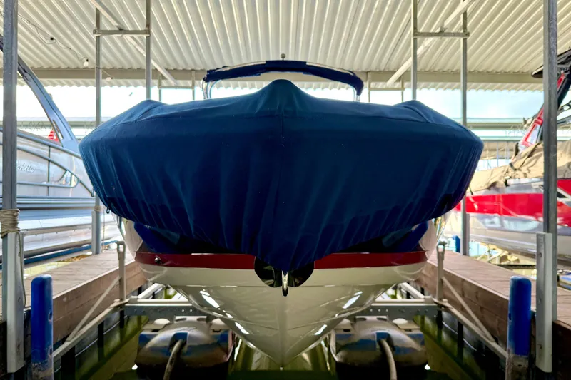 Slide: The Image of 2006 Cobalt 272 boat with blue cover in a marina dock. - 61