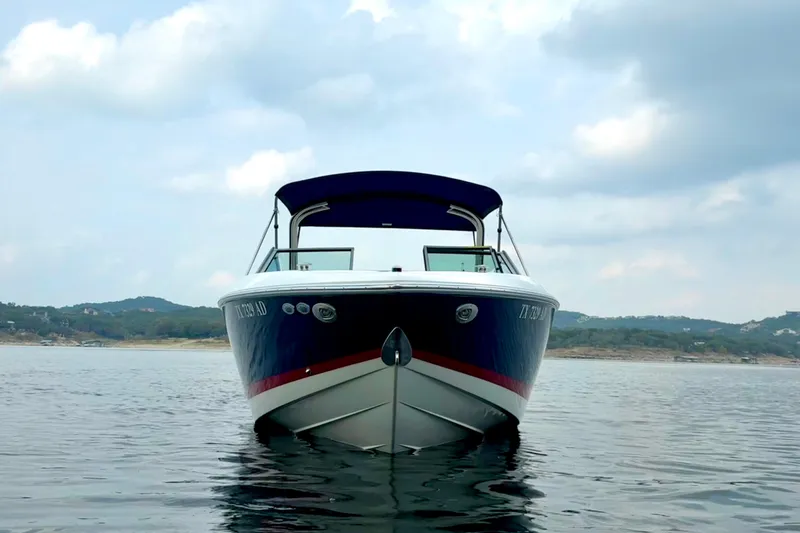 Slide: The Image of 2006 Cobalt 272 boat on calm water with scenic hills in the background. - 8