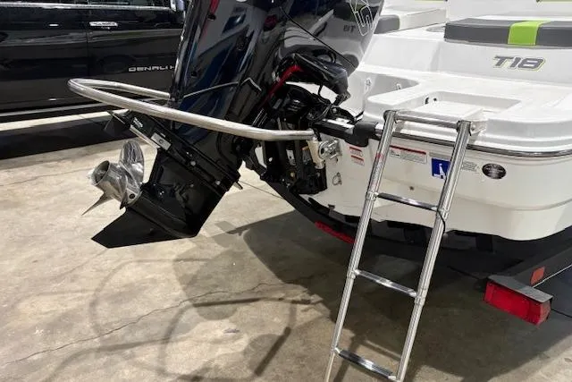 Slide: The Image of 2024 Tahoe T18 boat with outboard motor and ladder on display. - 10