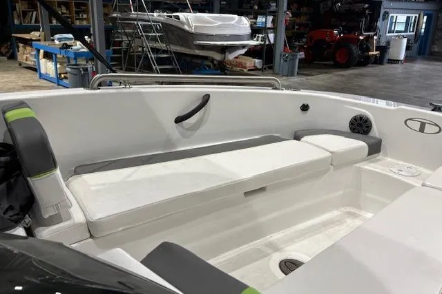 Slide: The Image of 2024 Tahoe T18 boat interior with white seating in a workshop setting. - 11